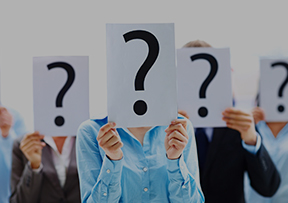 people standing in a group holding cards with question marks in front of there faces